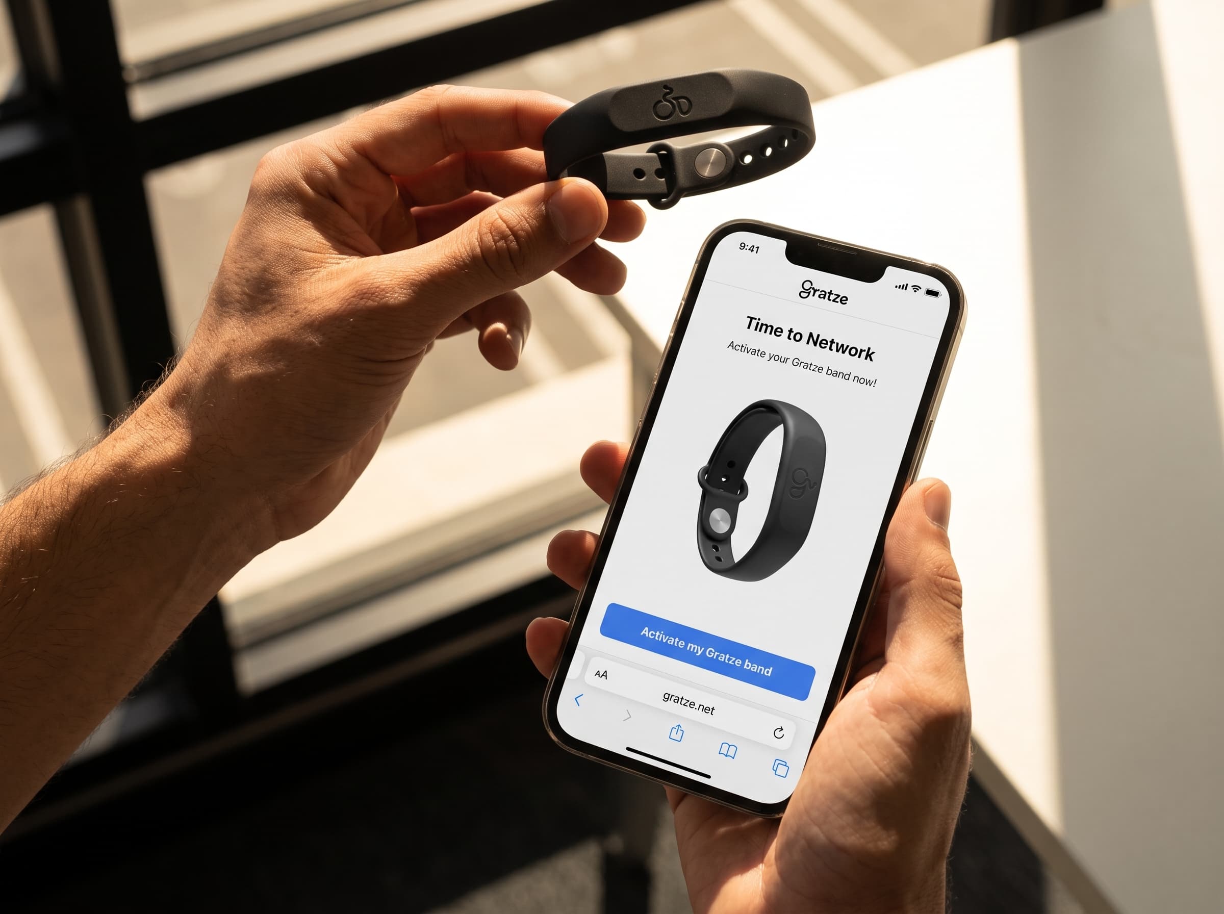Holding a Gratze wristband beside the band activation screen
